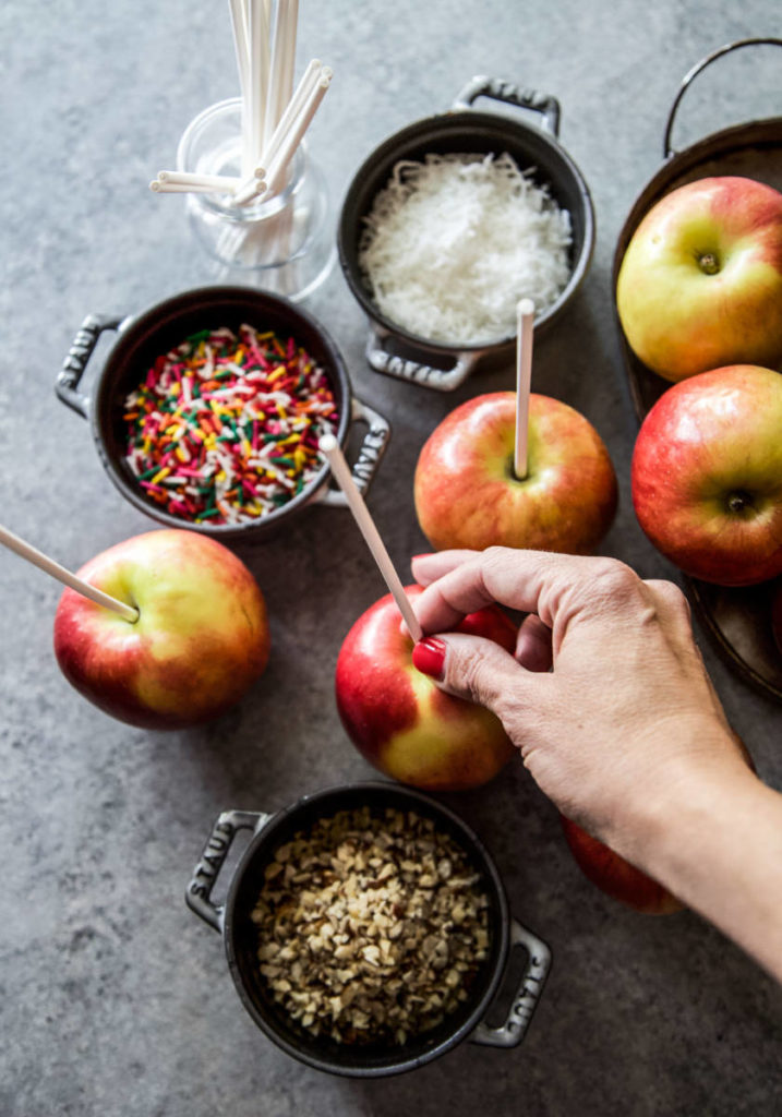 A photo of caramel apples diy a hand making caramel apples