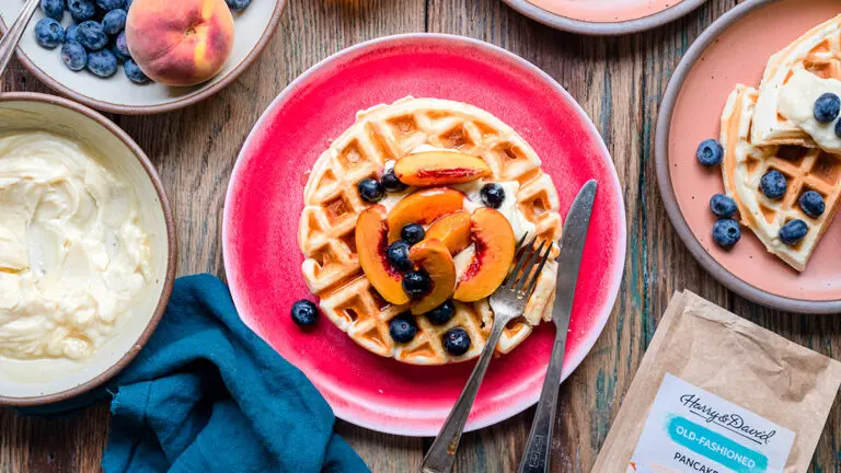 How to make waffles with pancake mix with a plate full of waffles and fruit.