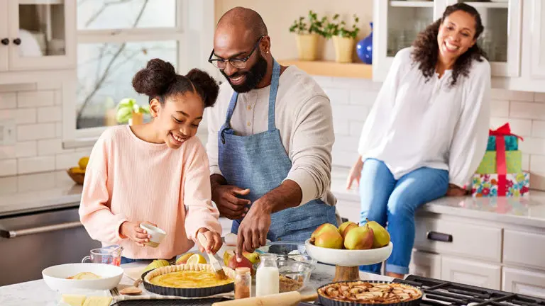 A photo of mother's day brunch ideas with a family cooking in a large kitchen