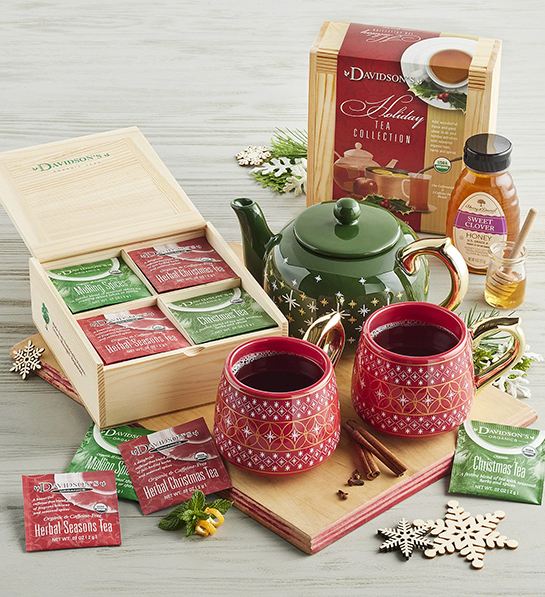 Christmas tea set with a tea pot, two mugs, and a box of tea bags.