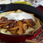 A photo of a Dutch baby with sliced pears