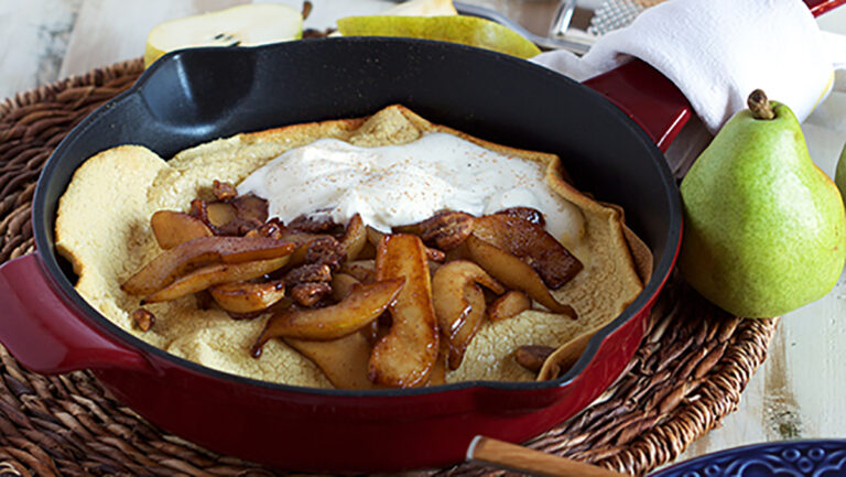 A photo of a Dutch baby with sliced pears