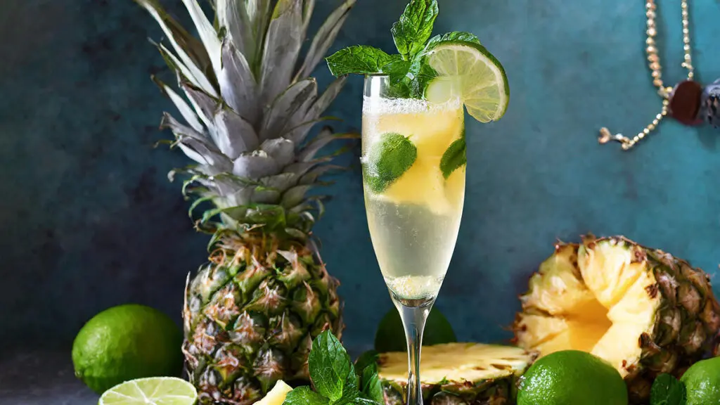 Pineapple cocktail with a pineapple in the background.