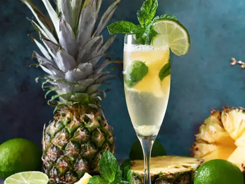 Pineapple cocktail with a pineapple in the background.
