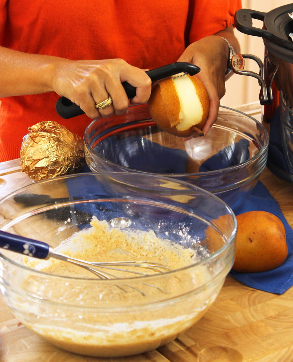 Someone peeling pears for a pear cake.