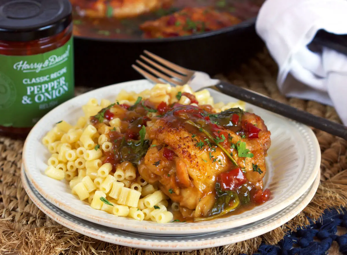 Pepper Onion Relish Chicken image - pepper & onion relish chicken served on a bed of pasta with jar in the background.