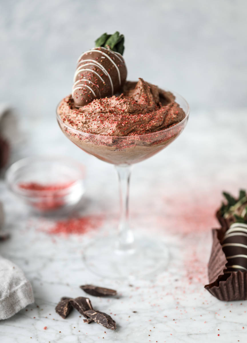 Valentine's Day dessert ideas with a cup of chocolate mousse topped with a chocolate covered strawberry.