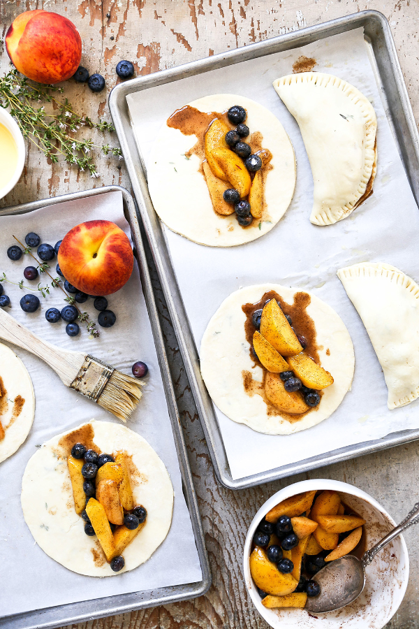 Peach blueberry pies in the assembly process.