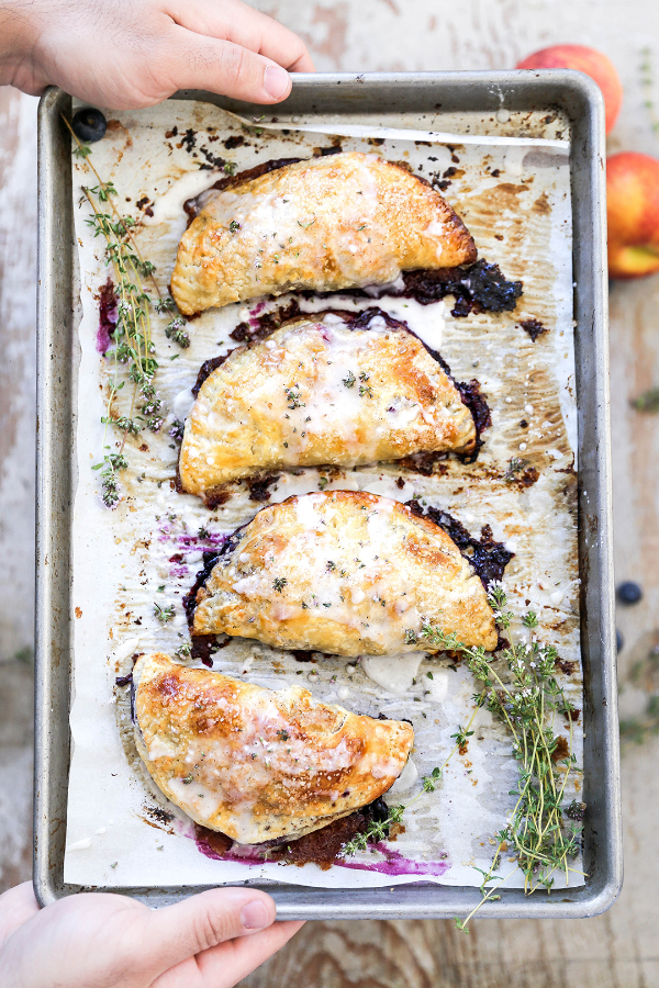 Peach blueberry pies on a sheet pan.