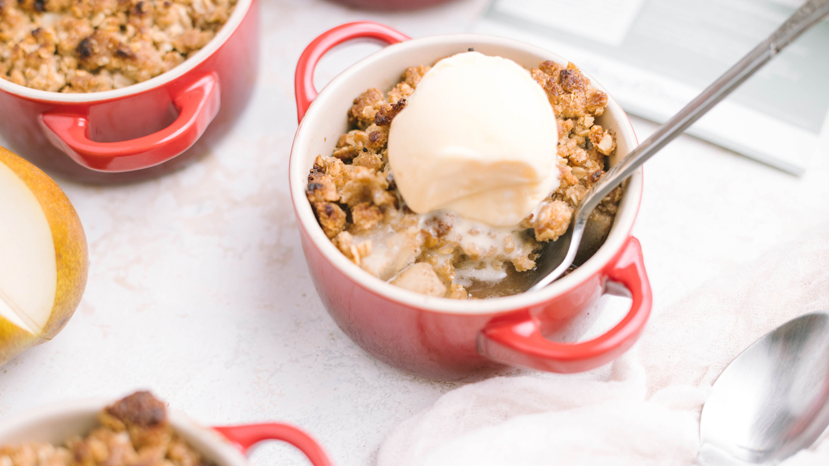 Pear crumble topped with ice cream.