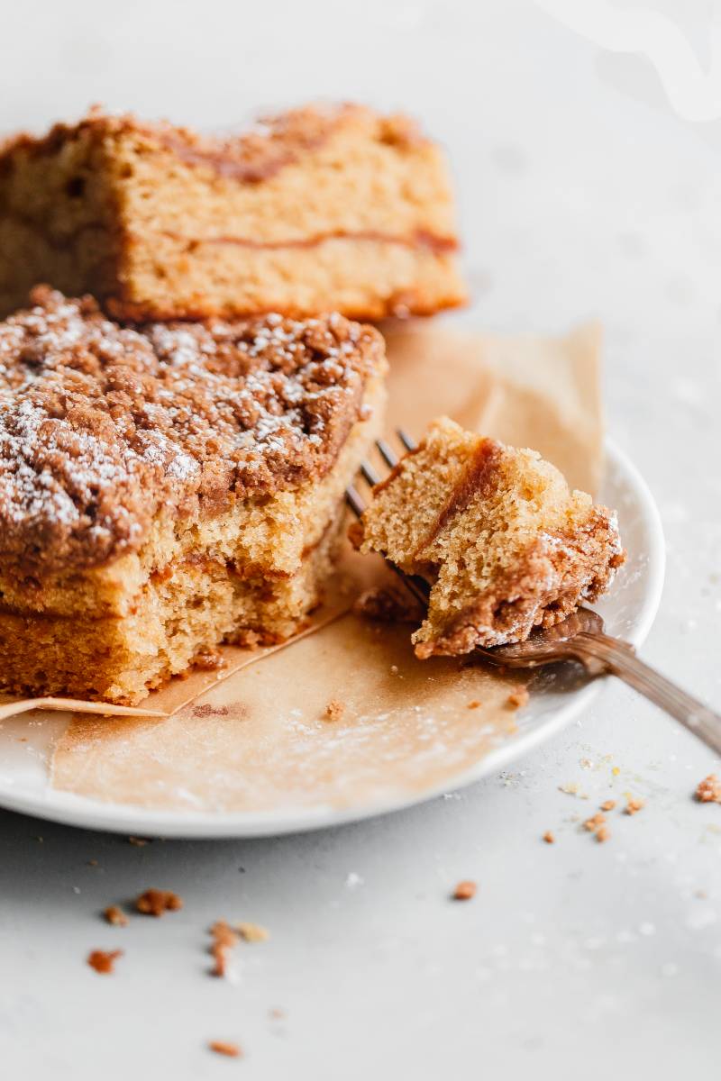 Pumpkin recipes with spiced coffee cake with pumpkin butter swirl on a plate.