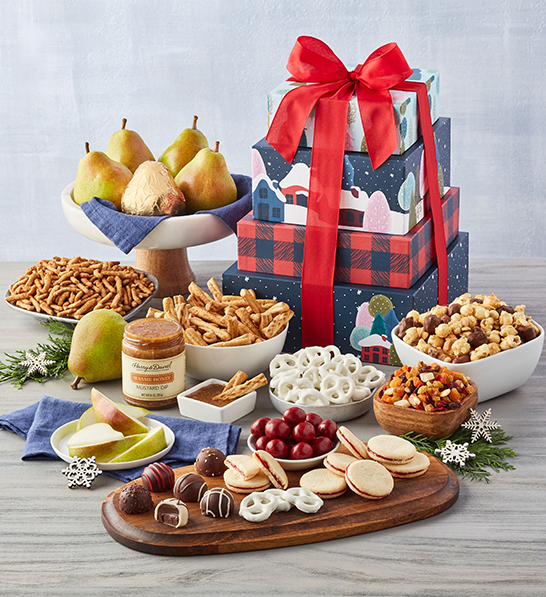 A photo of holiday gifts for him with a david holiday gift tower with fruit, chocolate, and nuts surrounding a tower of wrapped boxes