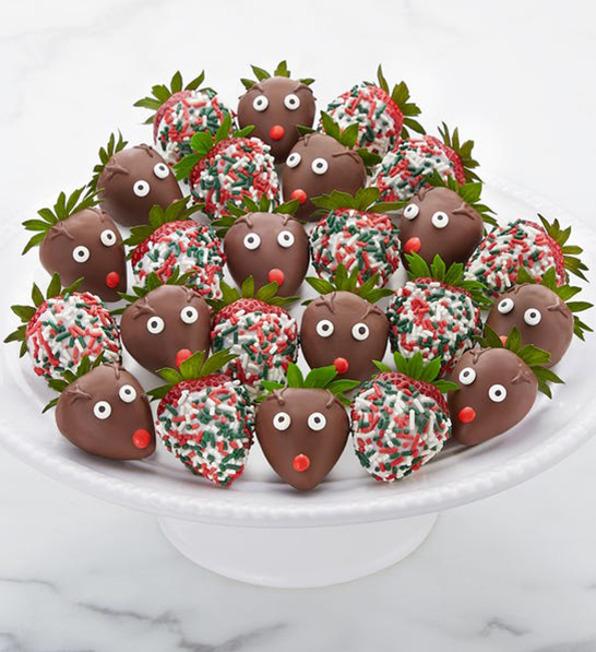 Christmas gift ideas for him with a tray of chocolate covered strawberries decorated to look like reindeer.