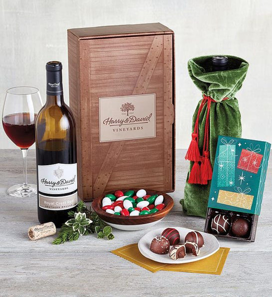 A photo of holiday gifts for him with a wine gift complete with chocolate truffles and jordan almonds