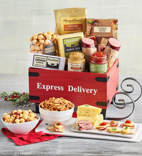 A photo of holiday gifts for him with a meat and cheese sled gift