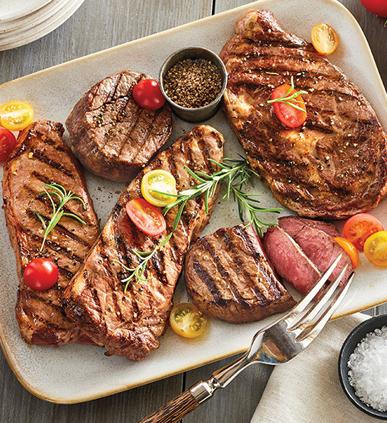 Christmas gift ideas for him with a plate of different cooked steaks.