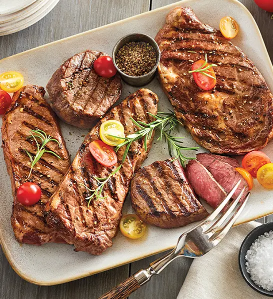 Christmas gift ideas for him with a plate of different cooked steaks.