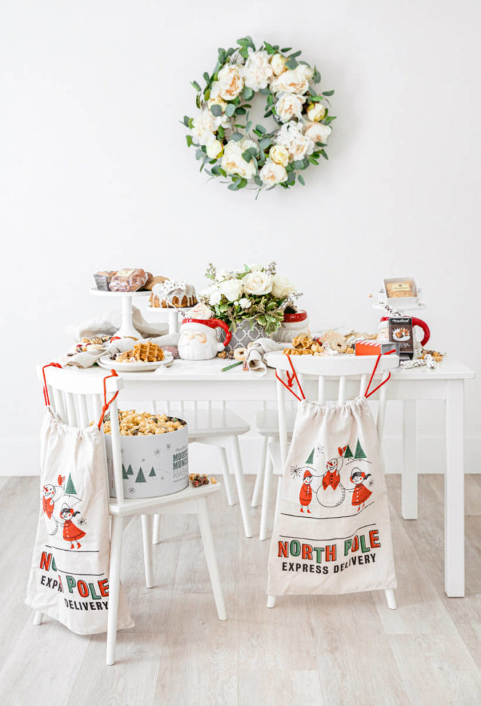 A photo of Christmas crafts for kids with a table full of cookies, cakes, waffles and a flower centerpiece