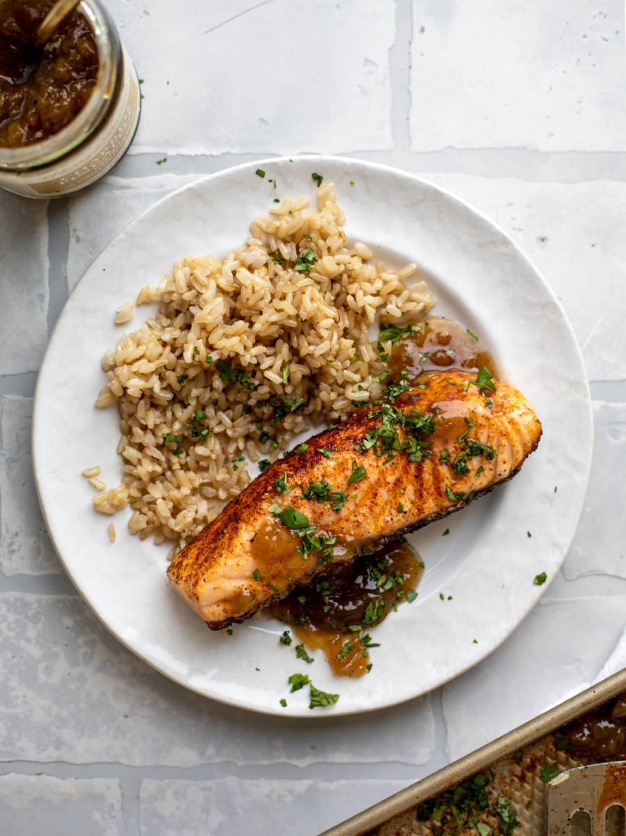 Grilled salmon recipe on a plate with rice.