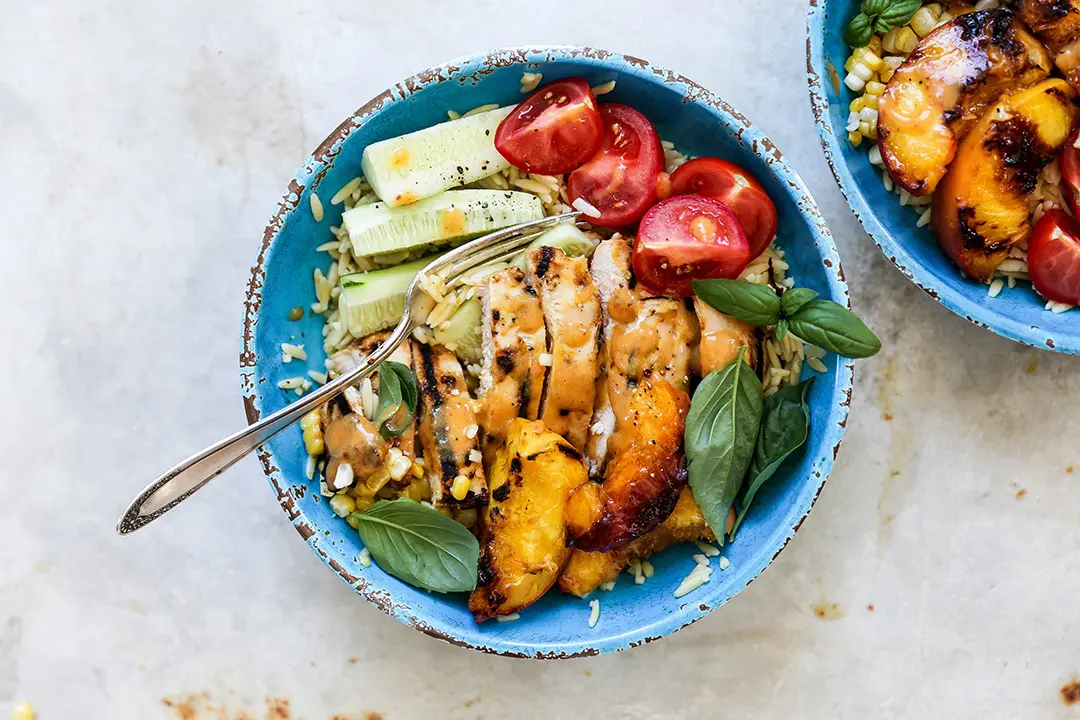 grilled chicken and peach bowl with peach dressing