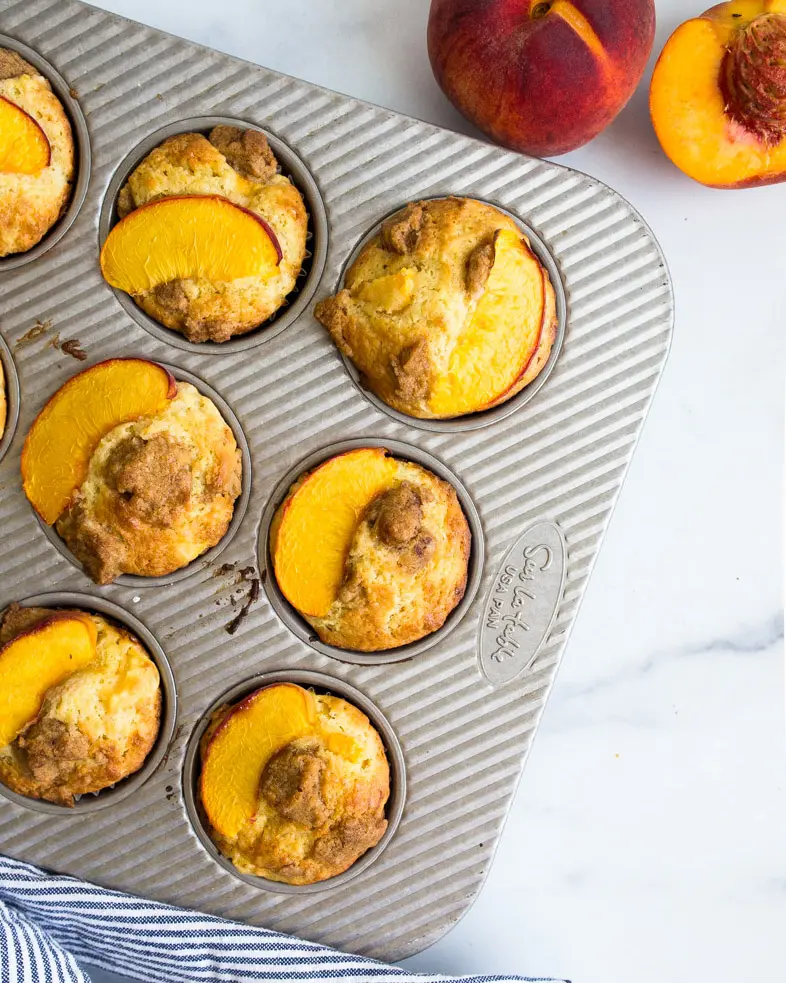 Peach muffins in a muffin tin