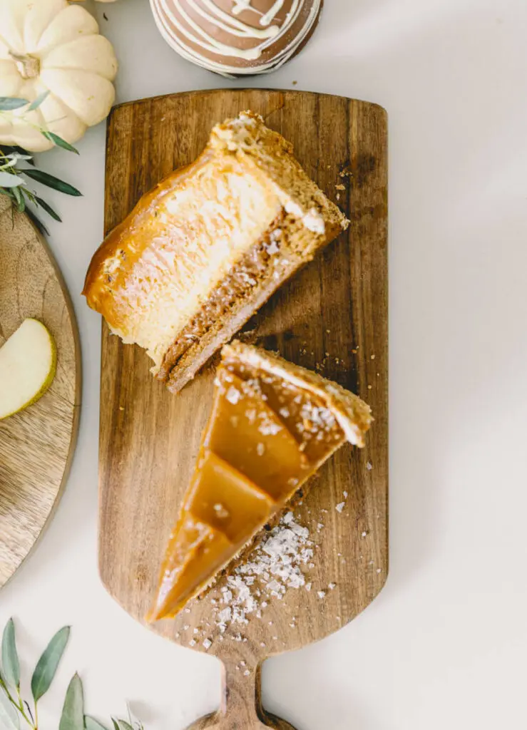 halloween snack board image - slices of caramel cheesecake on a wooden cutting board