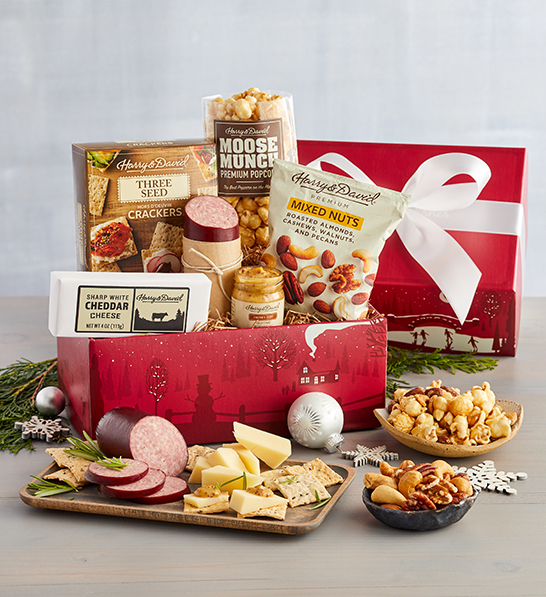 A photo of Christmas gifts under $30 with a box of meat, cheese, and snacks.