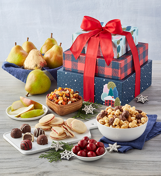 A photo of a gift guide with a stack of Christmas presents behind several bowls of snacks and a cutting board holding cookies and truffles with a bowl of pears next to them.
