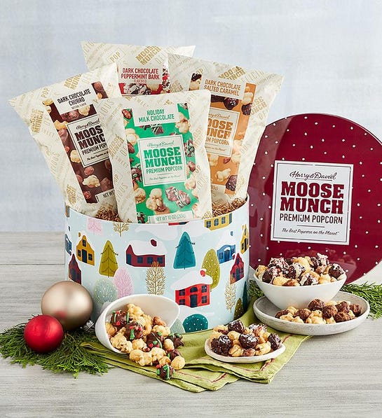 A photo of a gift guide with a tin of Moose Munch popcorn with a bowl of the same popcorn in front.