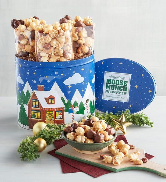 A photo of gifts under $50 with a tin of Moose Munch and a display of moose munch in a bowl in front