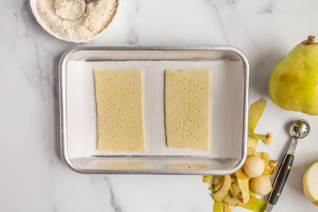 poking holes in pastry dough for pear tart recipe