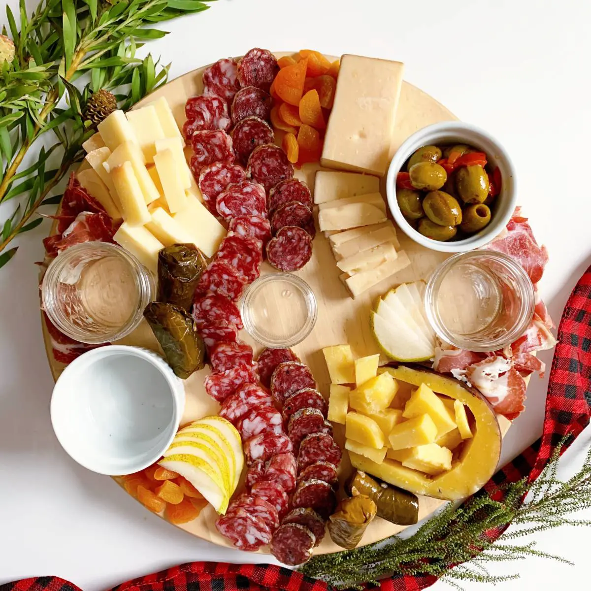 adding fruits and vegetables to a cheese board