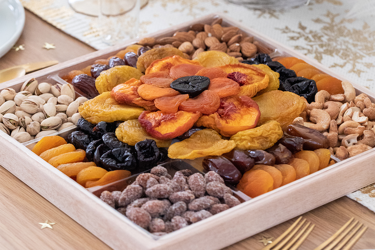A photo of traditional Hanukkah foods with a box full of dried fruit and nuts.