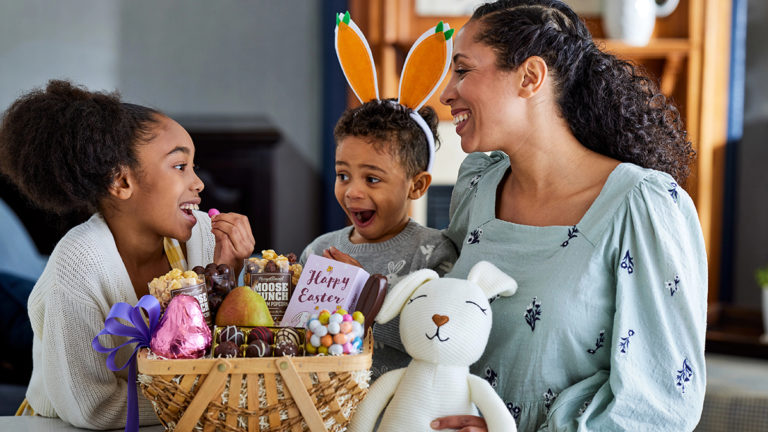 A photo of Easter basket stuffers with a family opening an Easter basket