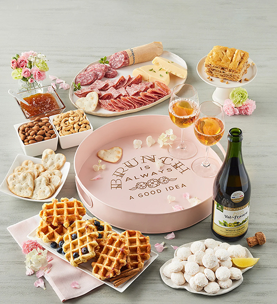 Mother's Day gift ideas with a brunch spread with waffles, cheese, meat, sparkling cider and more.