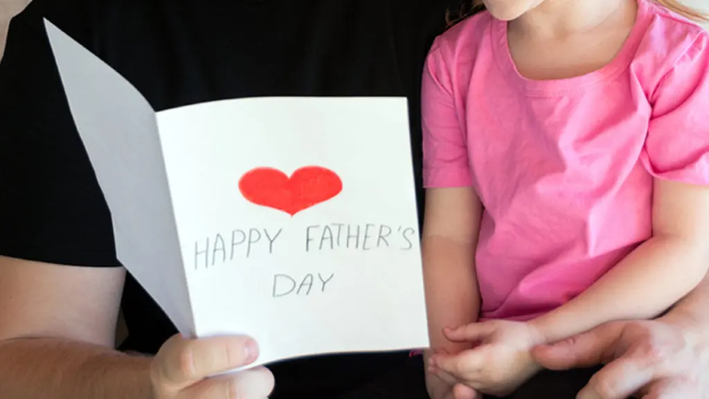 Father's Day ideas with a father reading a card from his daughter.