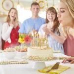 blowing out candles on a birthday cake