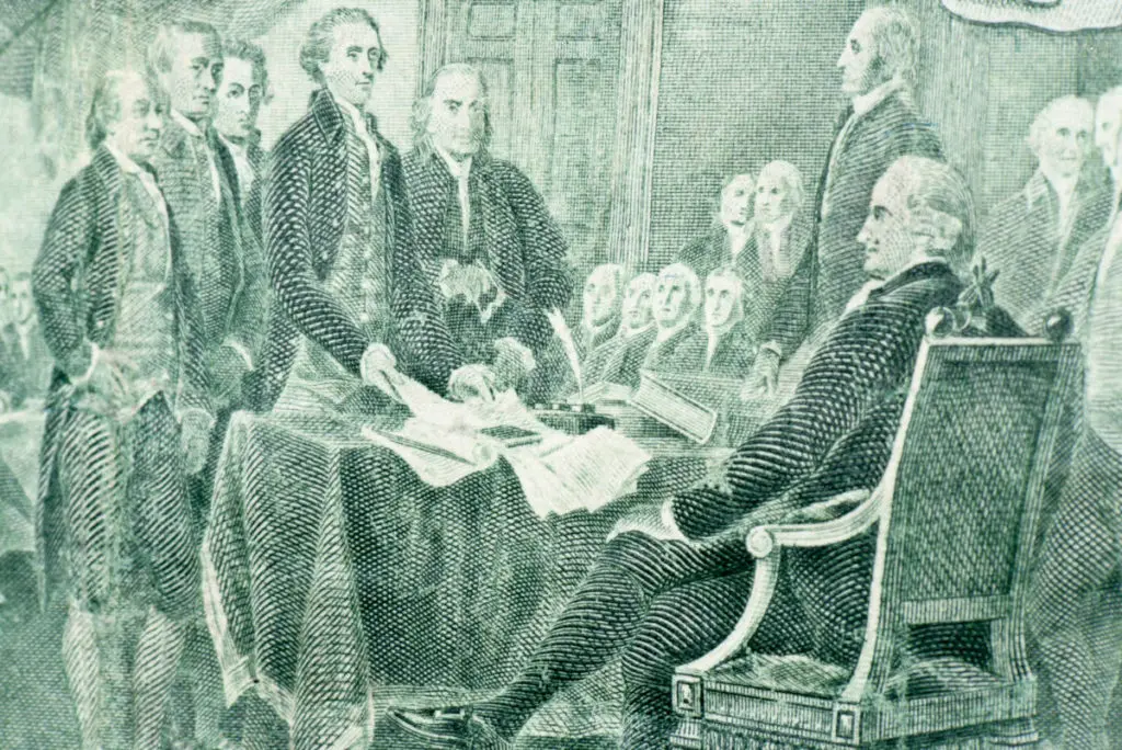 Photo of fourth of july with a drawing of the signing of the Declaration of Independence.