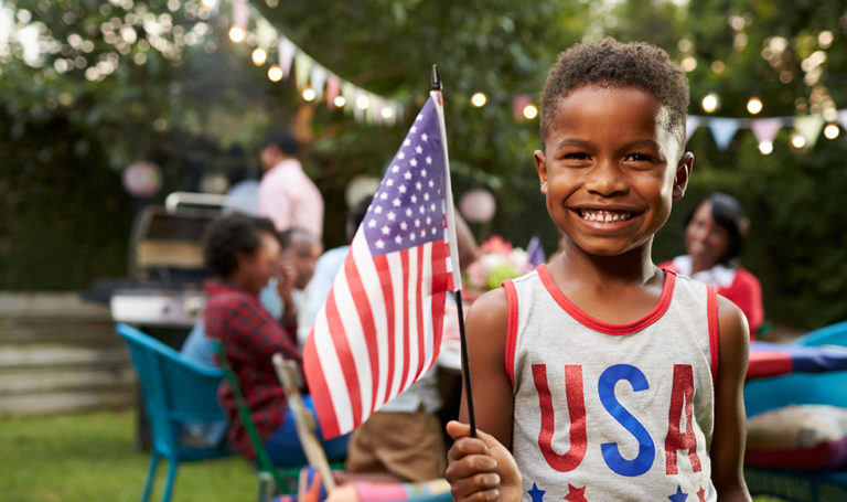 boy holding flag at 4th of July party