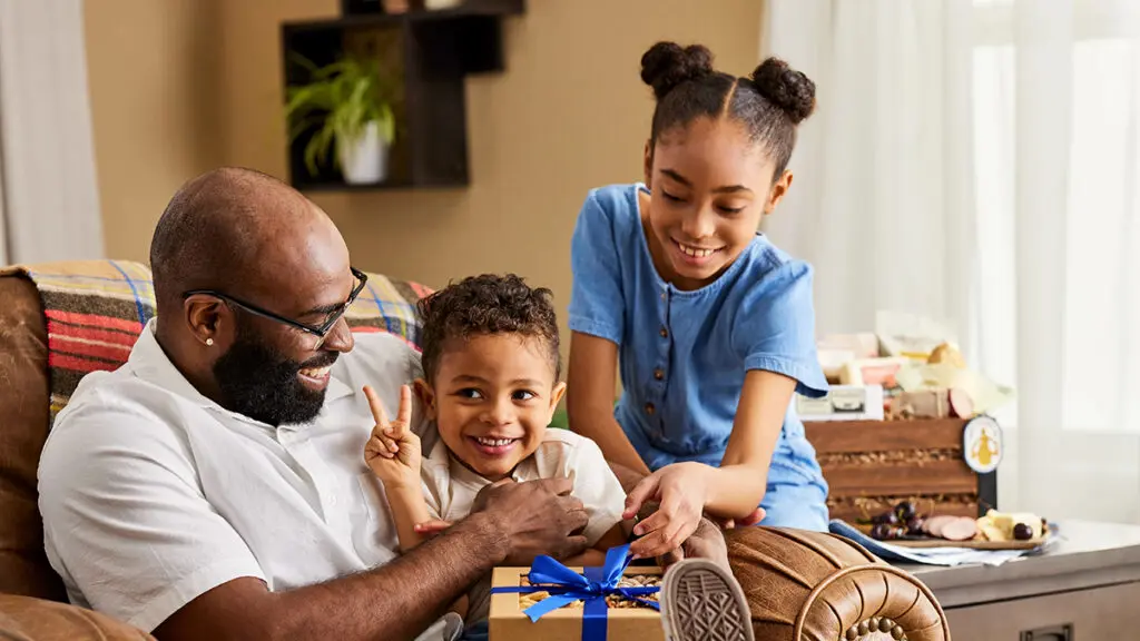 Two children giving their father a last-minute Father's Day gift.