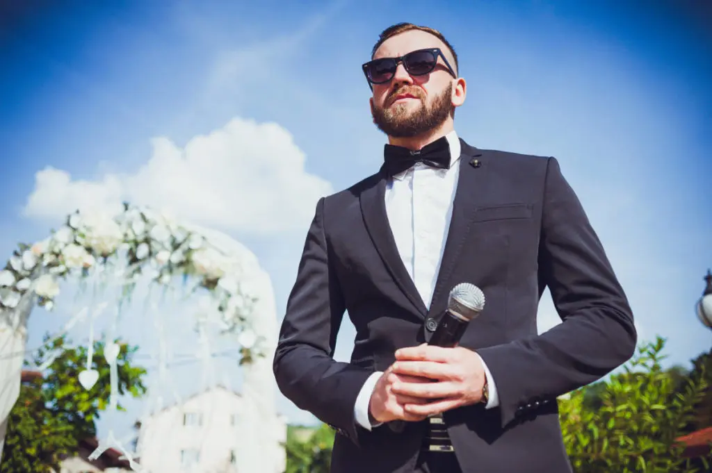 Presenter on stage with microphone. Wedding MC. Toastmaster