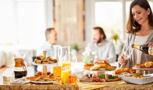 history of brunch -- woman pouring champagne image