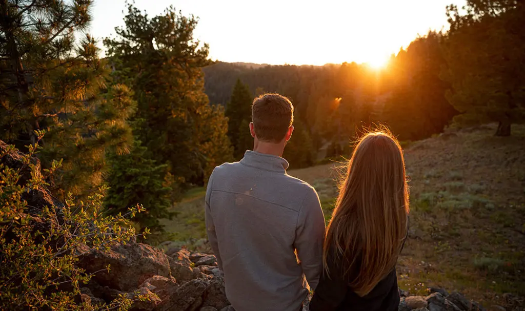 mindful vacation -- couple looking at sunset