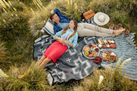 mindful vacation image -- couple napping on picnic blanket
