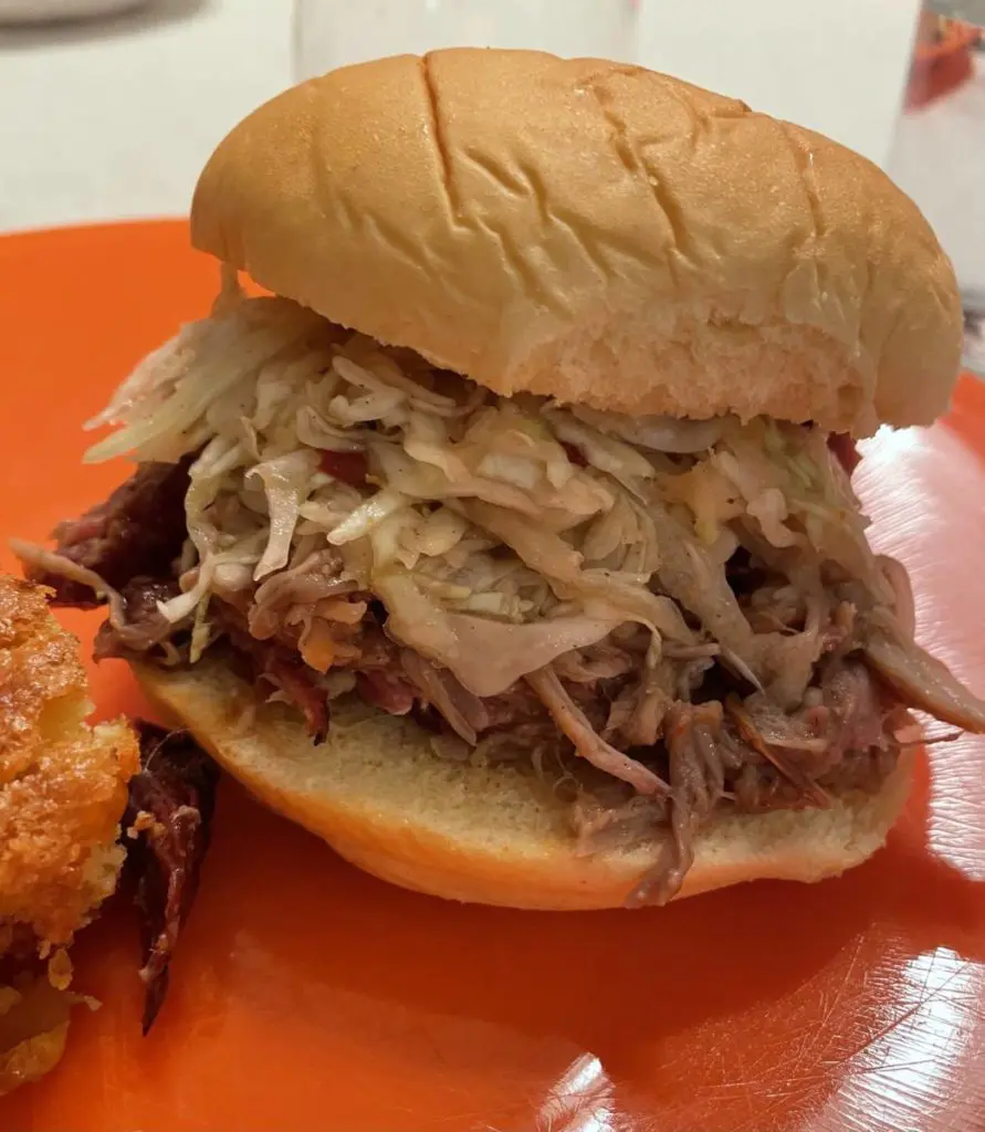 Photo of pulled pork sandwich on a plate.