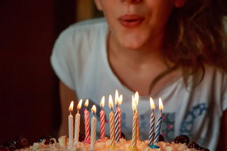 Birthday traditions image - woman blowing out birthday candles