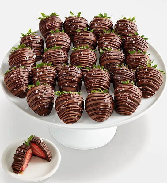 Chocolate caramel-covered strawberries on a platter.