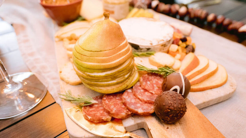 Closeup of sliced pears on a fall charcuterie board.