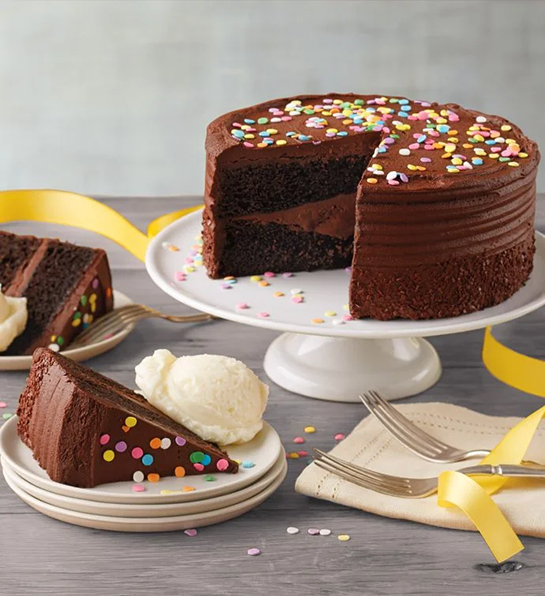 Favorite birthday gifts with a chocolate cake on a cake stand.