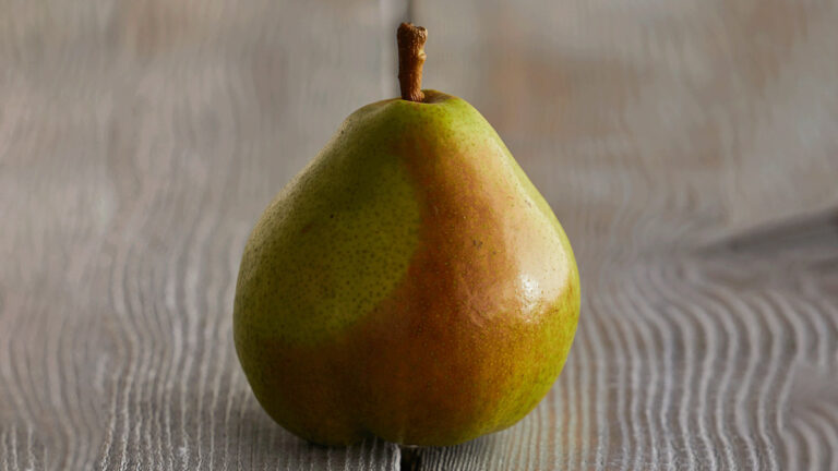 royal riviera pear image - pear on a grey wooden table